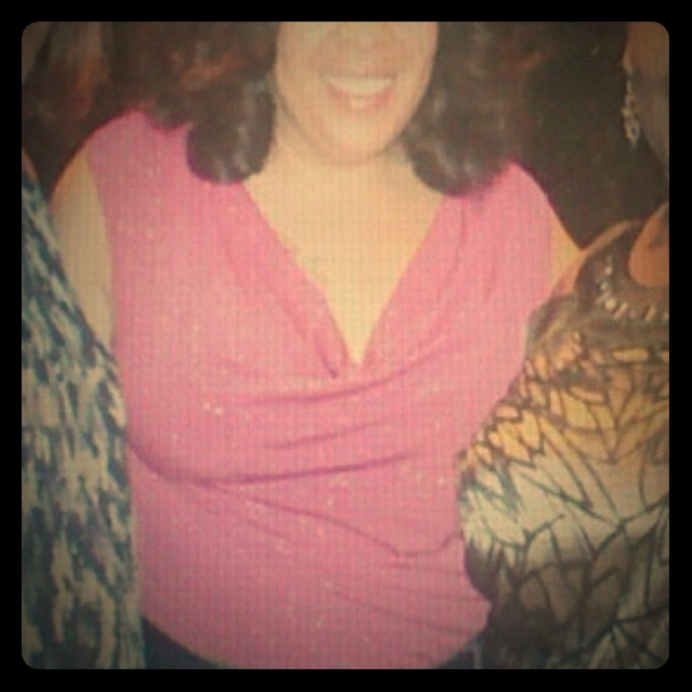 Pink sleeveless top with glitter detail.